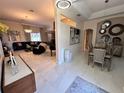 Open-concept living and dining area with stylish decor, elegant chandeliers, and bright, neutral colors at 4412 Conroy Club Dr, Orlando, FL 32835
