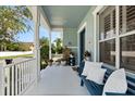 Inviting front porch with bench seating, columns, and white railing at 4608 Atwood Dr, Orlando, FL 32828