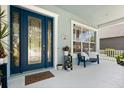 Inviting front porch with bench seating and decorative glass front door at 4608 Atwood Dr, Orlando, FL 32828
