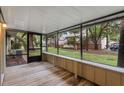 View from inside a screened porch that overlooks lawn with mature trees at 4772 Lake Ridge Rd # 66, Orlando, FL 32808