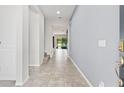 Bright foyer with tile flooring, leading into an open living space with views of the backyard at 4783 Riverwalk Dr, St Cloud, FL 34771