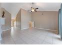 Bright living room with neutral paint, tile floors, vaulted ceiling, and fan at 622 Tomlinson Ter, Lake Mary, FL 32746