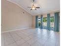 Large living room featuring vaulted ceilings, tile flooring, and natural light from large windows at 622 Tomlinson Ter, Lake Mary, FL 32746