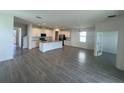 Bright kitchen features a large island, white cabinetry, stainless steel appliances, and expansive tile flooring at 7116 Cherry Pasture Rd, Groveland, FL 34736