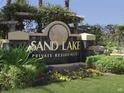 Elegant Sand Lake Private Residences community sign, surrounded by greenery at 7606 Pissarro Dr # 14206, Orlando, FL 32819