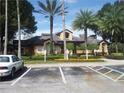 Community clubhouse with mature trees, landscaping and convenient parking at 7606 Pissarro Dr # 14206, Orlando, FL 32819