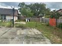 View of the property's backyard with a concrete area at 7625 Jarvis Ct, Orlando, FL 32818