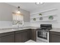 Galley-style kitchen features granite countertops, stainless steel appliances, and ample storage at 826 S Montgomery Ave, Deland, FL 32720
