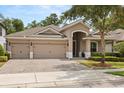 Inviting single-story home featuring a three-car garage and a well-maintained front yard with mature trees at 886 Sherbourne Cir, Lake Mary, FL 32746