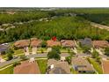 Aerial view of a single Gathering home with a lush tree lined view from the back of the property at 9852 Caroline Park Dr, Orlando, FL 32832
