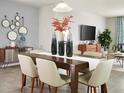 Elegant dining room with a wooden table, stylish chairs, and decorative mirrors on the wall at 1114 Cumberland Trail Dr, Lake Hamilton, FL 33851