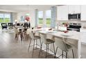 Open-concept kitchen with a large island, modern appliances, and seamless flow to the living area at 1114 Cumberland Trail Dr, Lake Hamilton, FL 33851