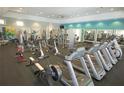 Well-equipped fitness center with treadmills, stationary bikes, weight machines, and plenty of open space for exercise at 11182 Hollow Bay Dr, Winter Garden, FL 34787