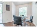 Cozy dining area features a glass table, stylish chairs, and natural light from a window at 11526 Westwood Blvd # 735, Orlando, FL 32821