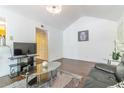 Bright living room with hardwood floors, vaulted ceiling, and comfortable black leather sofa at 11526 Westwood Blvd # 735, Orlando, FL 32821