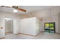 Open-concept living area featuring neutral walls, tiled flooring, and sliding glass doors at 1241 Leatherwood Dr, Altamonte Springs, FL 32714