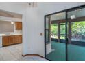 View of an enclosed lanai through sliding glass doors, and a partial view of the kitchen at 1241 Leatherwood Dr, Altamonte Springs, FL 32714