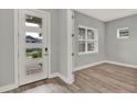 Entry way featuring a stylish front door with glass panels and wood-look floors at 14826 Deaton Aly, Orlando, FL 32827
