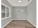 Neutral room features new wood floors, modern baseboards and multiple bright, light-filled windows at 14826 Deaton Aly, Orlando, FL 32827