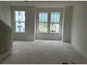 Bright living room with large windows offering natural light and views of the neighborhood at 15089 Grove Lake Dr, Winter Garden, FL 34787