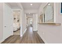 Long hallway with doors to bedrooms and living areas at 1524 Groveline Rd, St Cloud, FL 34771