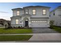 Charming two-story home with manicured lawn and a two-car garage at 1575 Plunker Dr, Davenport, FL 33896