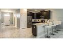 Modern kitchen featuring stainless steel appliances, dark wood cabinetry and breakfast bar at 1575 Plunker Dr, Davenport, FL 33896