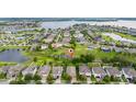 Aerial view of a residential neighborhood with a lake and pond showcasing the surrounding community at 15862 Citrus Grove Loop, Winter Garden, FL 34787