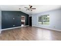 Spacious living room with wood-look tile flooring and natural light at 18 Palmira Rd, Debary, FL 32713