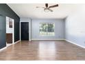 Bright living room featuring wood-look tile flooring, neutral walls, and a ceiling fan at 18 Palmira Rd, Debary, FL 32713