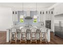 Well-appointed kitchen island with seating, pendant lights, and stylish backsplash at 1891 Lake Spier Dr, Winter Park, FL 32789