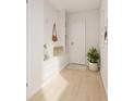 Bright entryway featuring storage, seating, and light hardwood floors at 209 Breezeway Dr, Davenport, FL 33897
