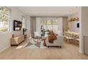 Inviting living room and dining area with modern decor and light hardwood floors at 209 Breezeway Dr, Davenport, FL 33897