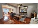 Inviting living room with hardwood floors and a seamless transition to the dining area at 2157 Island Walk Dr, Orlando, FL 32824