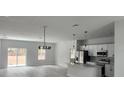 Bright, open-concept living room featuring sleek floors, recessed lighting, and an adjacent kitchen with modern finishes at 2333 Sw 147Th Pl Rd, Ocala, FL 34473