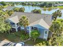 Scenic aerial view of a condo building near a tranquil lake, framed by mature trees and well-maintained lawns at 2501 Grassy Point Dr # 103, Lake Mary, FL 32746