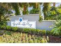 Elegant community entrance sign, 'Regency Park at Lake Mary Luxury Condominiums' surrounded by lush greenery and colorful flowers at 2501 Grassy Point Dr # 103, Lake Mary, FL 32746