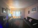 Inviting living room featuring modern furnishings, a sofa, and window lighting at 2506 Perrine Pl, Orlando, FL 32808