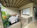 Cozy, covered front porch with seating, plants, and a charming entrance at 2506 Perrine Pl, Orlando, FL 32808