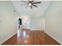 Spacious living room with hardwood flooring, vaulted ceiling, and modern ceiling fan offers a bright open layout at 3300 Se 22Nd Ave, Ocala, FL 34471