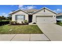 Beautiful one-story home featuring a well-kept lawn, tidy landscaping, and an attached two-car garage at 3329 Royal Tern Dr, Winter Haven, FL 33881