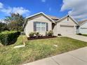 Lovely single-Gathering house offering a lush green lawn, tidy landscaping, and a convenient two-car garage at 3329 Royal Tern Dr, Winter Haven, FL 33881
