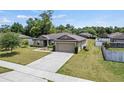 Single-story home with a two car garage and a long driveway at 337 Southern Winds Blvd, Deland, FL 32720