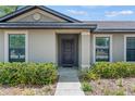 Close-up of the front door featuring a decorative wreath, surrounded by manicured landscaping at 337 Southern Winds Blvd, Deland, FL 32720