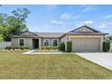 Lovely single-story home with a well-manicured lawn and an attached two-car garage at 337 Southern Winds Blvd, Deland, FL 32720