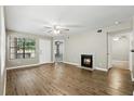 Inviting living room featuring a fireplace, wood floors, and ample natural light at 485 Forestway Cir # 108, Altamonte Springs, FL 32701