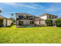 Spacious backyard with a screened pool enclosure and lush green lawn, ideal for outdoor activities and Gathering enjoyment at 5007 Bellthorn Dr, Orlando, FL 32837
