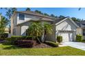Well-maintained home exterior featuring lush lawn, decorative landscaping, and an attached two-car garage in a Gathering-friendly community at 5007 Bellthorn Dr, Orlando, FL 32837