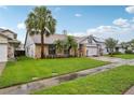 Beautiful front yard featuring lush green grass and mature palm trees enhancing curb appeal at 520 Starstone Dr, Lake Mary, FL 32746