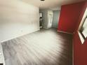 Bright living room featuring new floors, fresh paint, and ample natural light from a large window at 605 Pleasantdale Dr, Wildwood, FL 34785